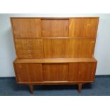 A 20th century teak sliding door sideboard