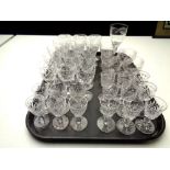 A tray of various cut glass and etched crystal wine glasses