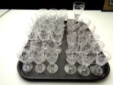 A tray of various cut glass and etched crystal wine glasses