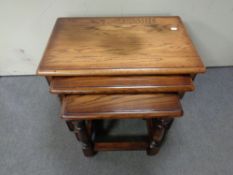 A nest of three oak tables