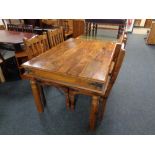 A rectangular Sheesham wood dining table and four chairs