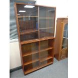 Two 20th century continental teak sliding glass door book cases