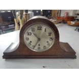 An early 20th century oak mantel clock with silvered dial