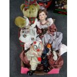 A box containing dolls and clown figures,
