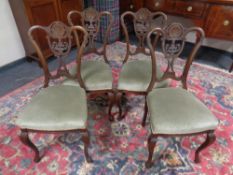 A set of four late Victorian dining chairs