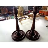 A pair of turned beech candlesticks