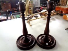 A pair of turned beech candlesticks