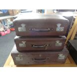 A set of three vintage graduated luggage cases