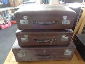 A set of three vintage graduated luggage cases