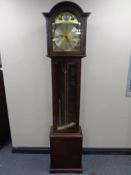 A contemporary Tempus Fugit longcase clock with pendulum and weights
