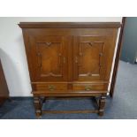 A continental oak two door cabinet