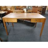 An Edwardian oak writing table fitted with two drawers