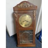 A 20th century oak case eight day wall clock