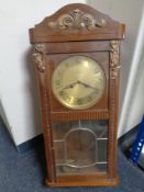 A 20th century oak case eight day wall clock