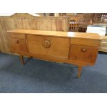 A 20th century teak low sideboard with fitted cupboards and drawers beneath