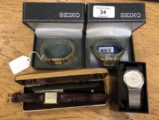 Three gold plated Seiko watches and a Skagen watch.