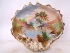 A hand painted shell shaped dish