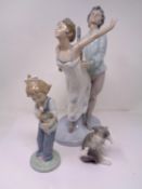 Three Lladro and Nao figures including Kitten with mouse, Girl with doll and Dancers.