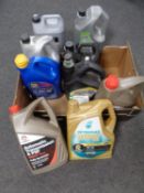 A box containing nine canisters of assorted motor oil, brake and clutch fluid, hydraulic oil,