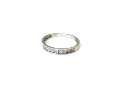 A 9ct white gold diamond half eternity ring, size O CONDITION REPORT: 1.