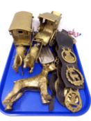 A tray containing horse brasses on leather straps,
