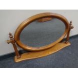 An oval pine dressing table mirror.