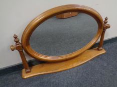 An oval pine dressing table mirror.