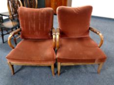 A pair of 20th century teak framed armchairs with dralon cushions