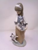 A Lladro figure - Girl with cat and kittens.