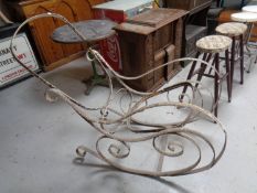 An antique cast iron rocking chair frame.