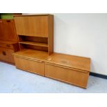 A mid century teak fall fronted bureau together with further matching cupboard