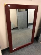 A contemporary mirror in a painted frame,