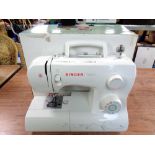 A Singer Talent electric sewing machine in box with lead and non-matching foot pedal.