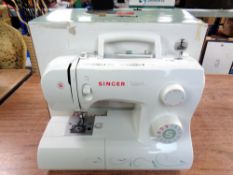 A Singer Talent electric sewing machine in box with lead and non-matching foot pedal.