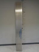 A contemporary chrome metal five bar wall mounted radiator.