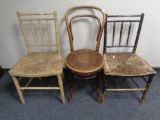 A bentwood chair together with a pair of antique faux bamboo rush seated kitchen chairs.