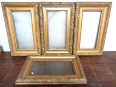 A set of four antique gilt picture frames. 63cm by 38cm.