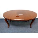 A mahogany extending oval dining table together with set of four stained pine dining chairs