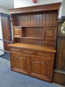 A good quality Victorian style oak Welsh dresser with fitted cupboards and drawers beneath.