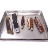 Six assorted pocket knives.