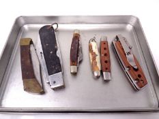 Six assorted pocket knives.