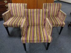 A set of six low back armchairs upholstered in a striped fabric.