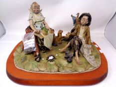 A Capodimonte figure of two tramps by Roberto Barmbilla on a wooden plinth (AF)