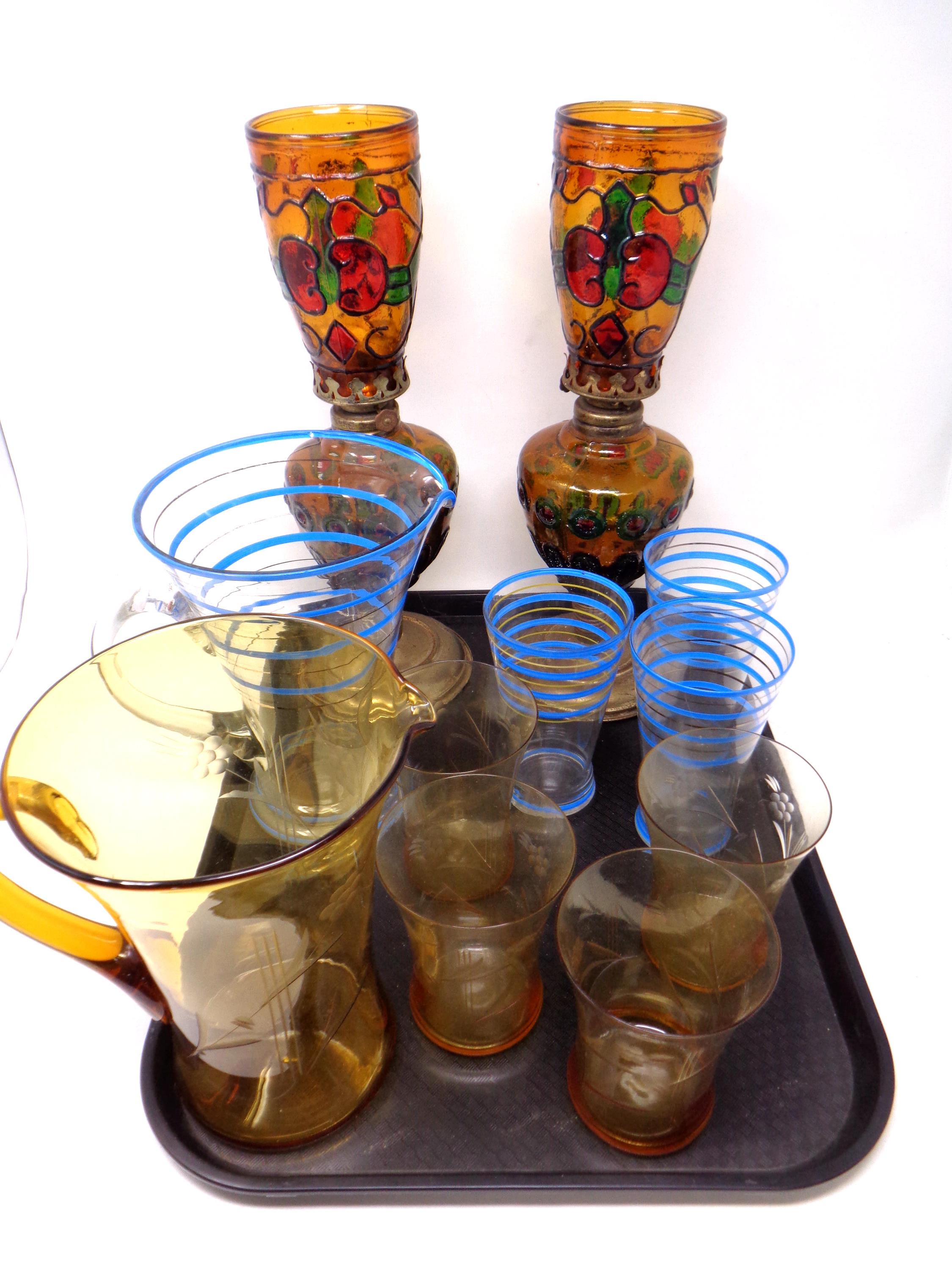 A tray containing two 20th century glass water jugs with seven beakers together with a pair of