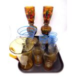 A tray containing two 20th century glass water jugs with seven beakers together with a pair of