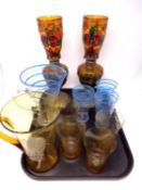 A tray containing two 20th century glass water jugs with seven beakers together with a pair of