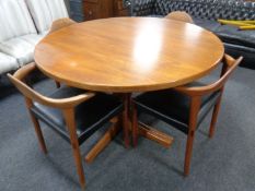 A 20th century circular teak pedestal dining table with a set of six Danish teak elbow chairs by