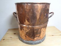 A 19th century copper twin handled pot.