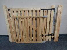 A pine garden gate together with a baby safety gate.