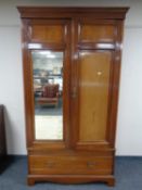 A 19th century mahogany double door wardrobe with fitted drawer beneath.
